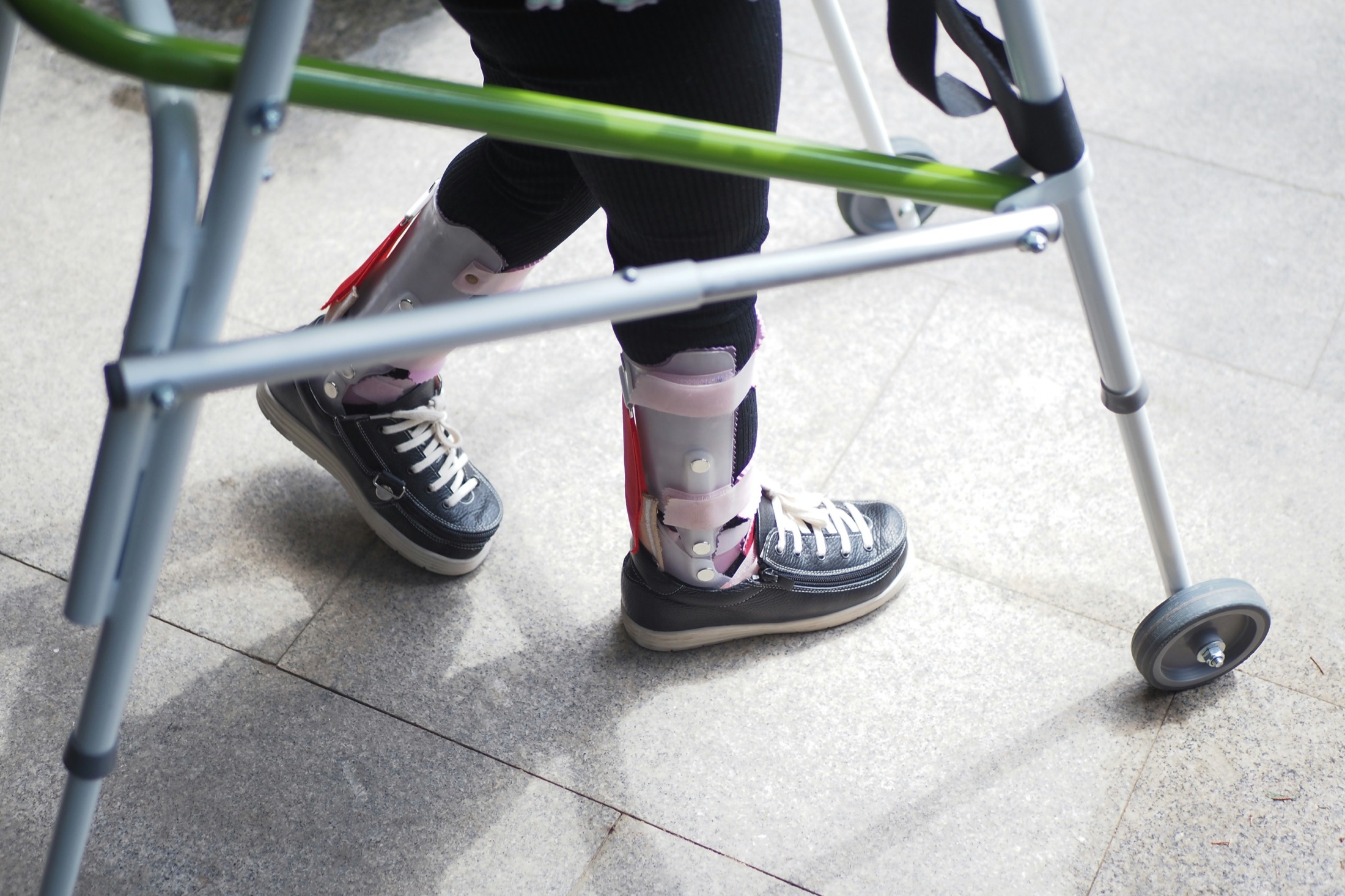 Child using a walker with orthotic support