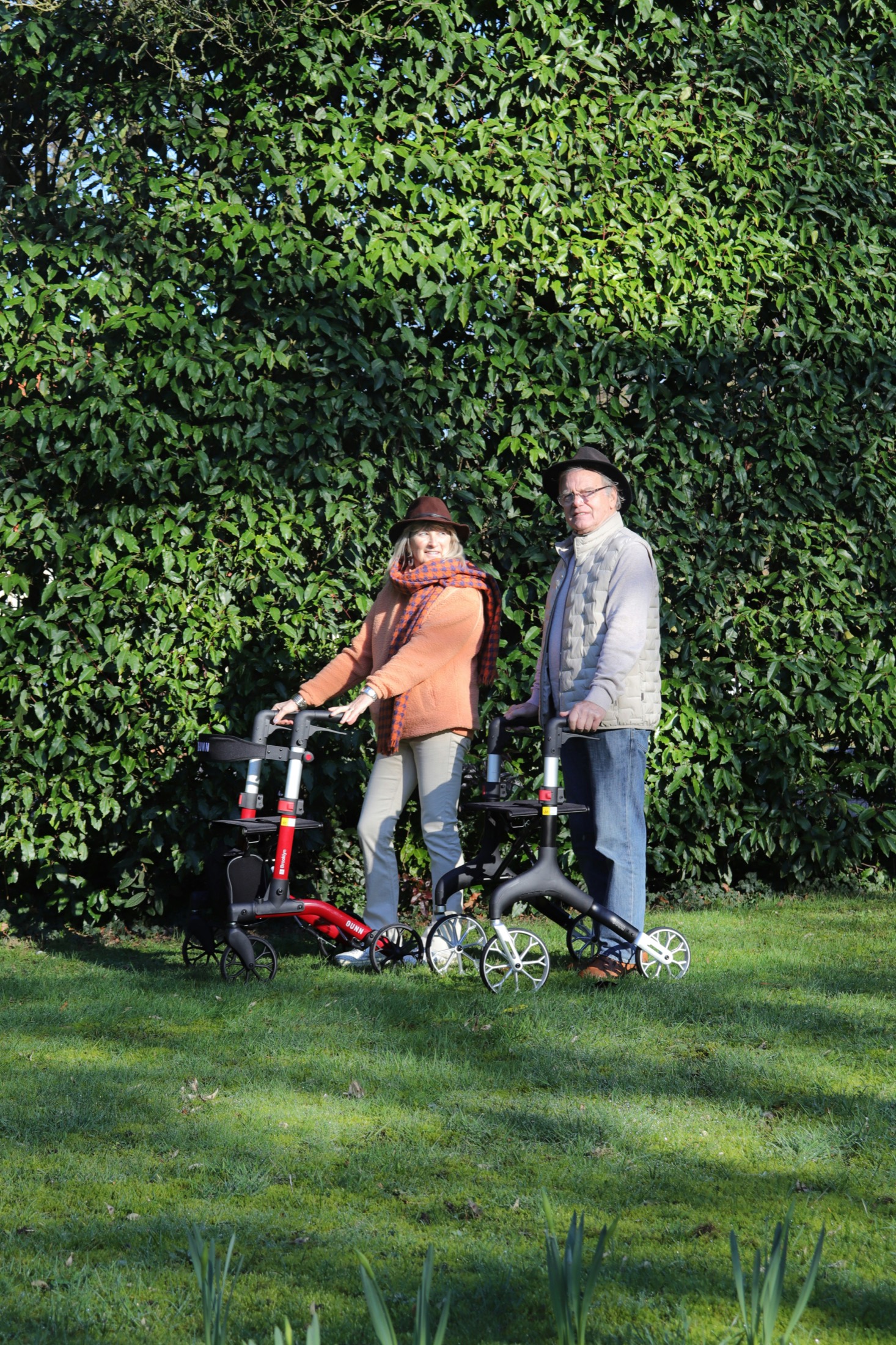 Older adults walking with rollators outdoors