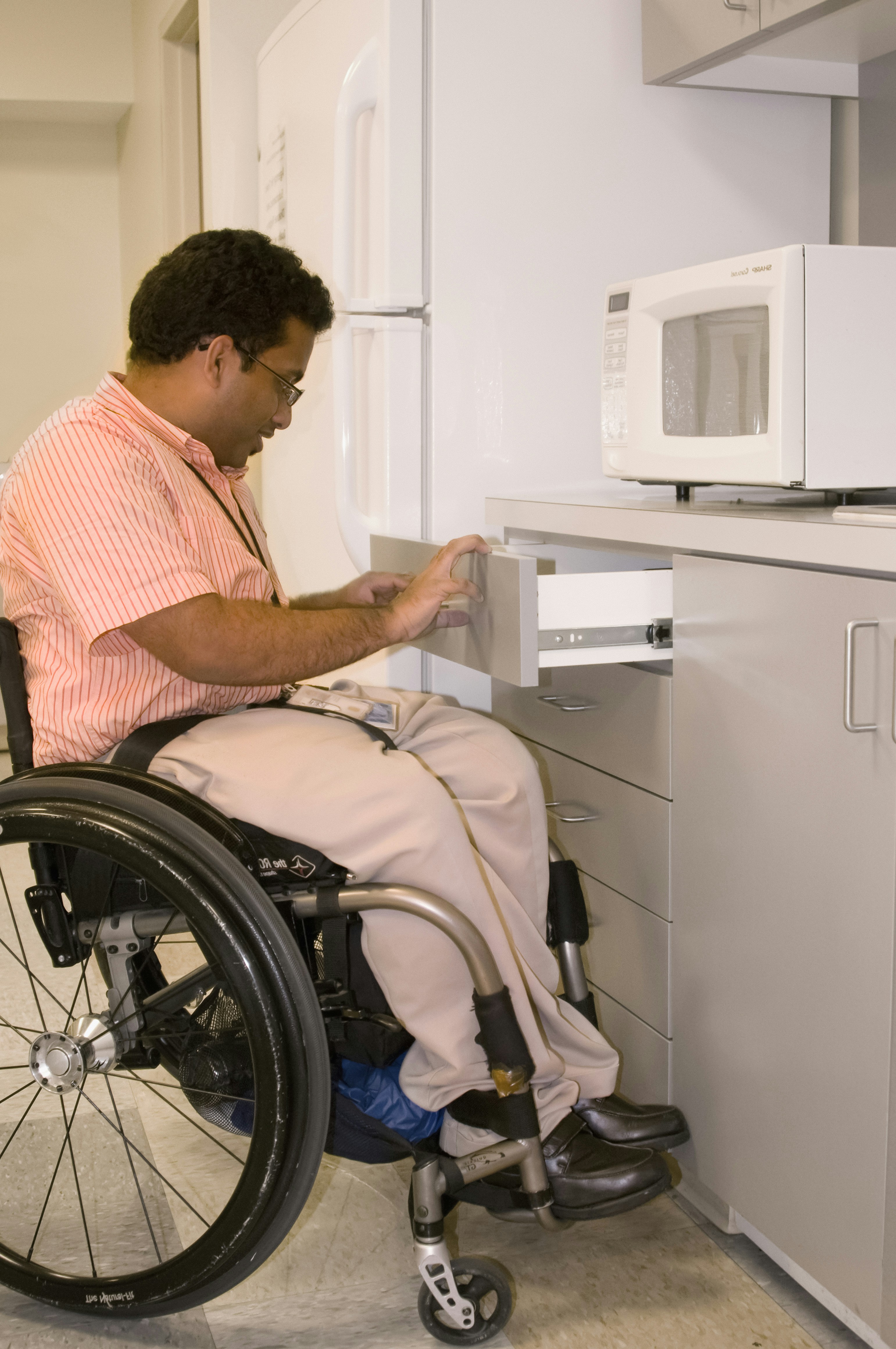 Wheelchair user using an accessible kitchen counter
