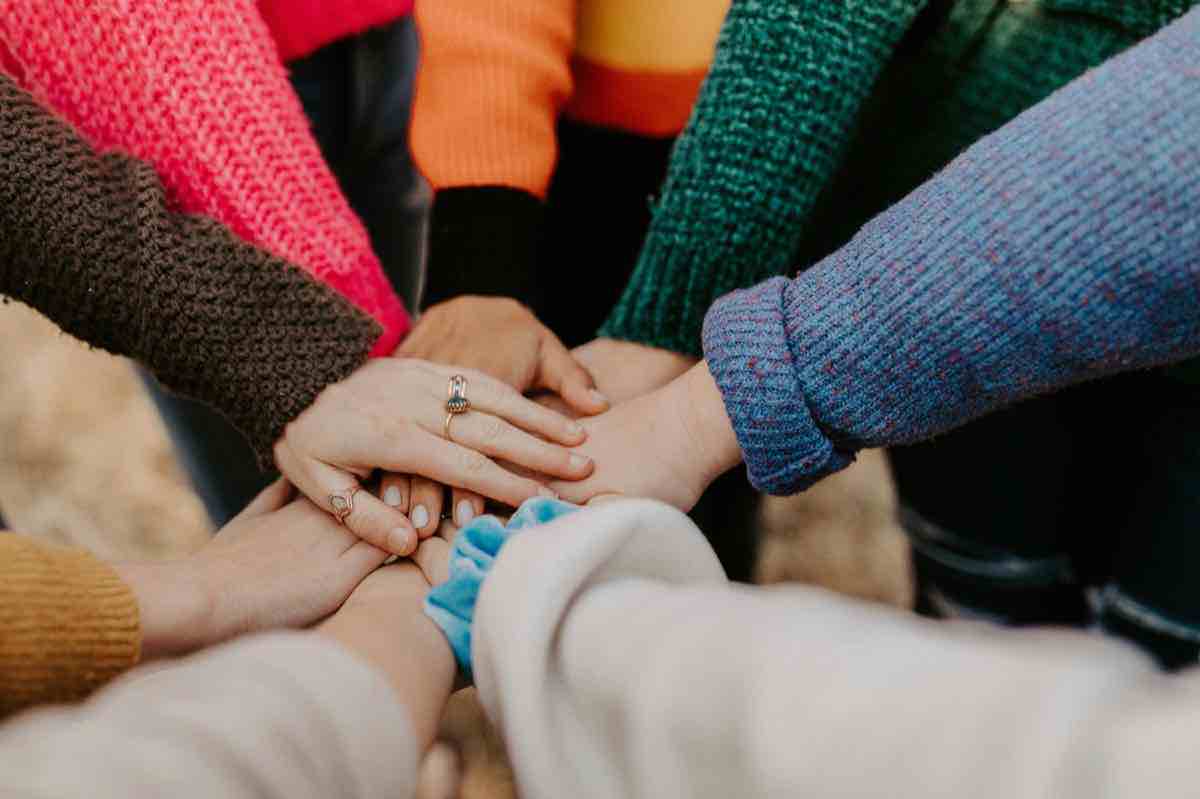 Community support and inclusion hands together