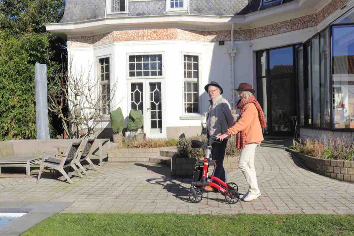 Older couple using rollators on a patio