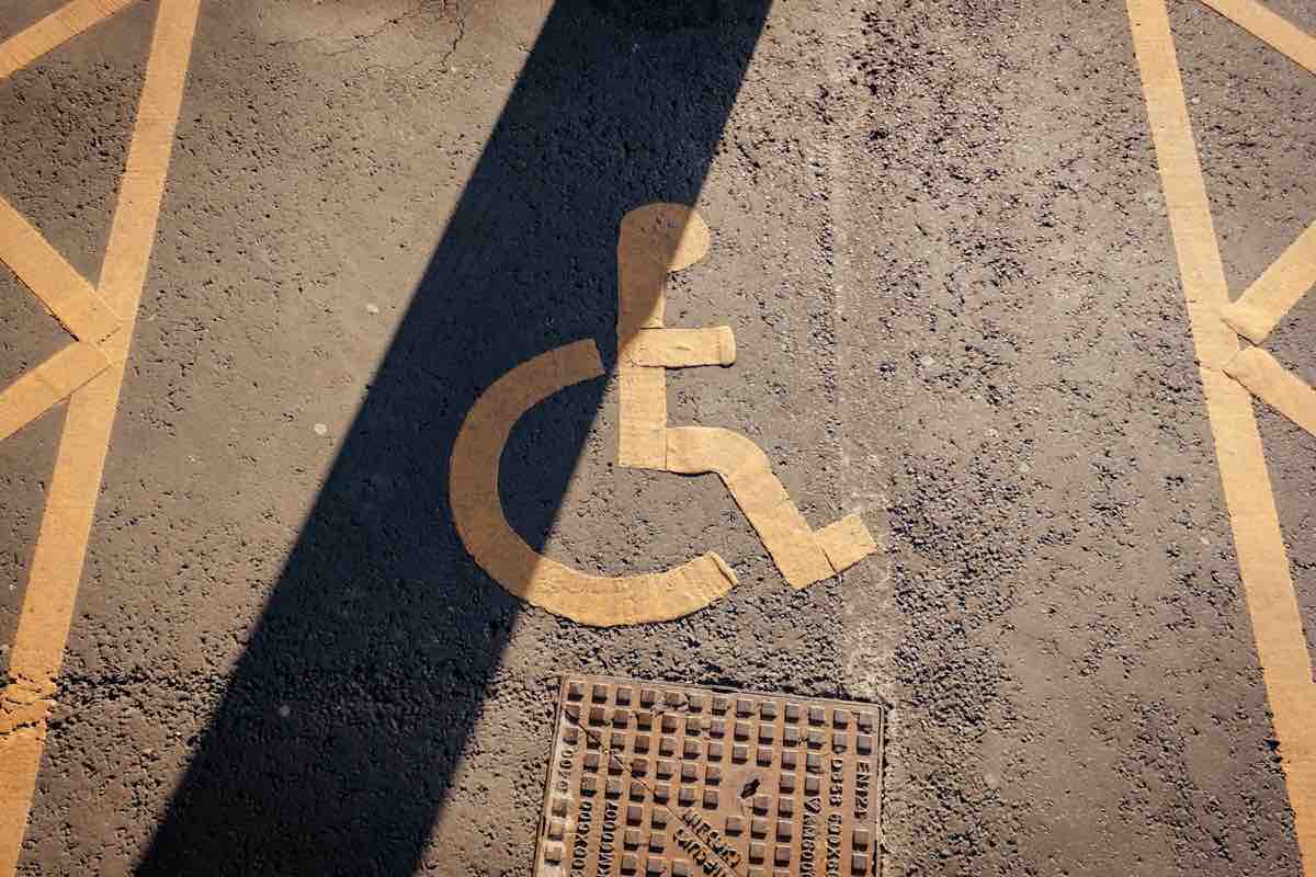 the shadow of a person in a wheelchair on the ground