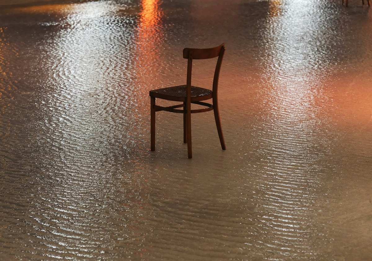 A chair sitting in the middle of a flooded street