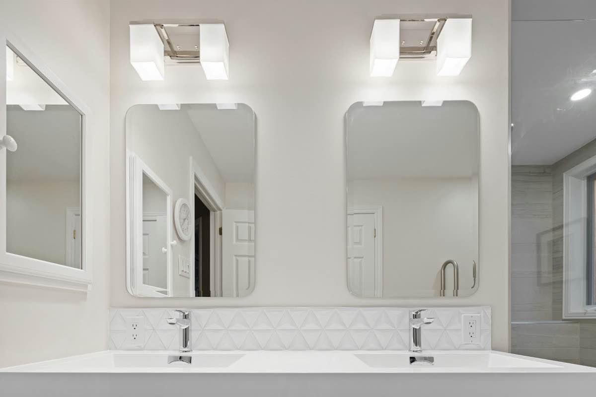 a bathroom with a couple of mirrors